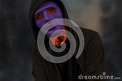 Mystery flame man with violet mask Stock Photo