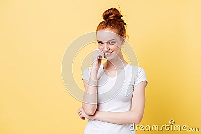 Mystery ginger woman in t-shirt bites her finger Stock Photo