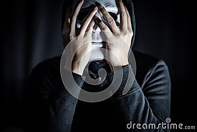 Mystery man wearing white mask Stock Photo