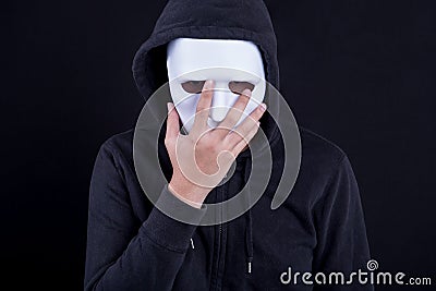 Mystery man wearing white mask for hide his face Stock Photo