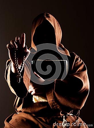 Mystery preaching monk with bible Stock Photo