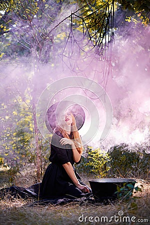 The forest enigmatic witch in the green wood outdoors. Stock Photo