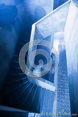 Mystic interiors, old abandoned unfinished building of Bokor Casino, empty and dark spiral staircase. Top view Stock Photo