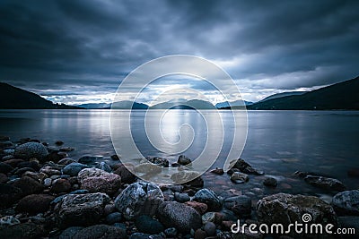 Mystic landscape lake scenery in Scotland: Cloudy sky, sunbeams and mountain range in loch Linnhe Stock Photo