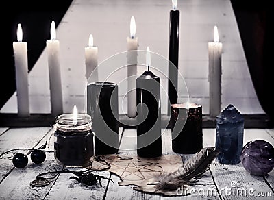 Mystic still life with black candles and pentagram on paper Stock Photo