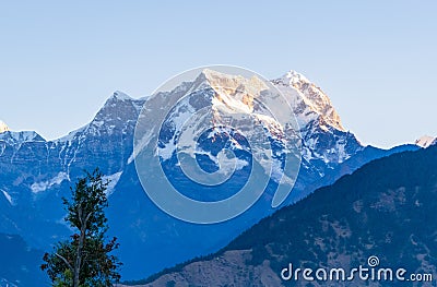 Mystical Chaukhamba peaks of Garhwal Himalayas during sunrise from Deoria Tal camping site. Stock Photo