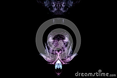 A mystical image of a ghost or an alien from green and purple smoke. Print for clothes Stock Photo