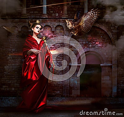 Mysticism. Witchcraft. Sorcerer in Red Mantle with Vulture - Hawk. Ancient Scary Castle Stock Photo