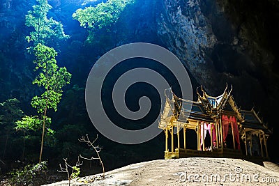 Mystique view to the Phraya Nakhon Cave with the Khuha Kharuehat Pavilion illuminated by Sun through the Hole in the Rocky Top Stock Photo
