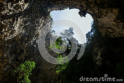 Mystique view to the Phraya Nakhon Cave with the Khuha Kharuehat Pavilion illuminated by Sun through the Hole in the Rocky Top Stock Photo