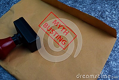 Myth Busting text on document above brown isolated on Office Desk Stock Photo