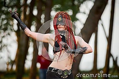 Mythological dancing girl faun on green lawn in public park outdoor art dancing event Stock Photo