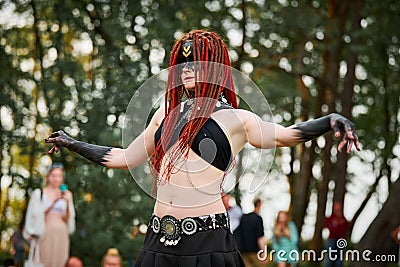 Mythological dancing girl faun on green lawn in public park outdoor art dancing event Stock Photo