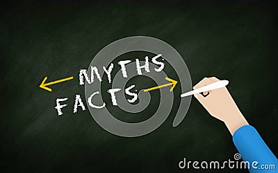 Myths and facts Chalkboard hand Writing text with Businessman Hand Stock Photo