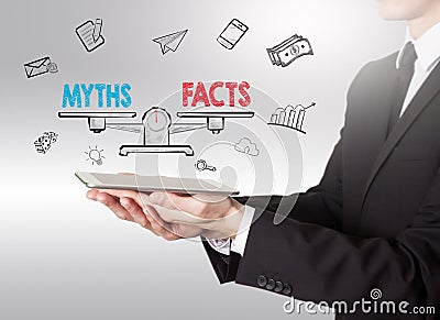 Myths vs facts Balance, young man holding a tablet computer Stock Photo