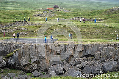 Tourists walk the walking trails to view Godafoss, a famous waterfall Editorial Stock Photo