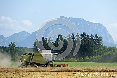 Combine harvester on grain field in the Salzkammergut Upper Austria, Austria Editorial Stock Photo