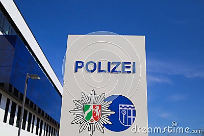 Isolated german Polizei logo in front of police station against blue sky Editorial Stock Photo