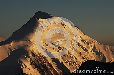 MÃ¶nchshÃ¼tte: GLobal clima change: Bernese swiss mountain peak with melting glacier at sunset near Grindelwald Stock Photo