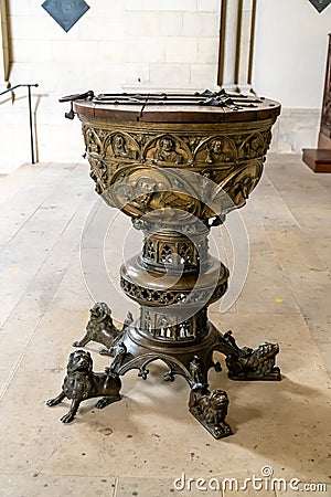 Bronze baptismal font with many decorations Editorial Stock Photo