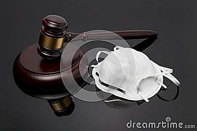 N95 face mask and gavel isolated on black background Stock Photo