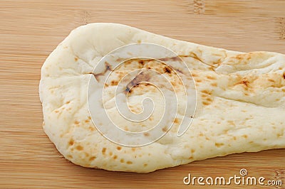 Naan indian bread on cutting board Stock Photo