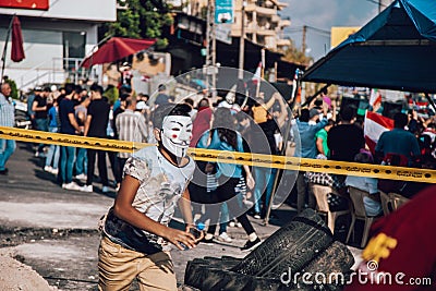 Boy wearing Guy Fawkes mask running in Lebanese Civil Protest Editorial Stock Photo