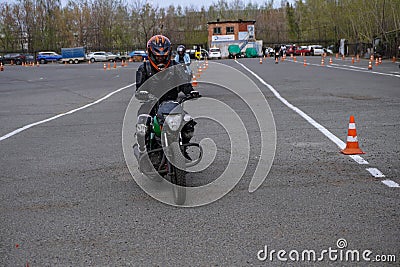 Naberezhnye Chelny, Russia - April 25, 2023: Young people learn to ride a motorbike in a motor school Editorial Stock Photo