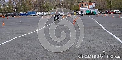 Naberezhnye Chelny, Russia - April 25, 2023: Young people learn to ride a motorbike in a motor school Editorial Stock Photo