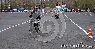 Naberezhnye Chelny, Russia - April 25, 2023: Young people learn to ride a motorbike in a motor school Editorial Stock Photo