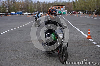 Naberezhnye Chelny, Russia - April 25, 2023: Young people learn to ride a motorbike in a motor school Editorial Stock Photo