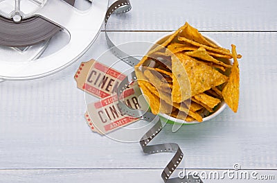 Nachos in a bucket, two tickets for movies and film, on a light gray background, close-up Stock Photo