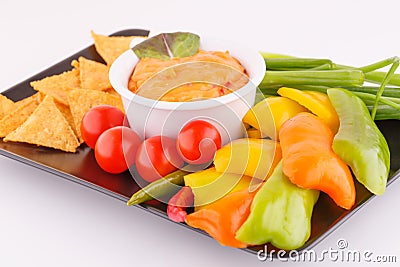 Nachos, cheese sauce, vegetables Stock Photo