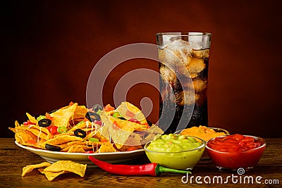 Nachos plate, dip and cola drink Stock Photo