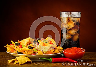 Nachos, salsa dip and cola drink Stock Photo