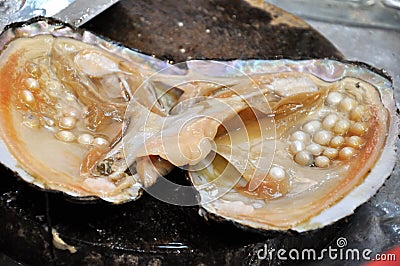 Nacre with raw pearl Stock Photo