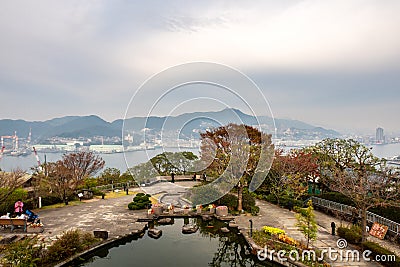 NAGASAKI, Japan, 03/11/19. Glover Garden pond, trees, flowers and a view point on the hill with Nagasaki Port, Japan. Editorial Stock Photo