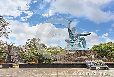 Peace Statue created by Japanese sculptor Seibo Kitamura aside the Orizuru no Tower in Nagasaki peace park. Editorial Stock Photo