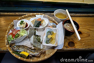 Nagashi Somen, japanese flowing noodle, served cold through long flume half cut of bamboo with dipping sauce, fresh grilled fish Stock Photo