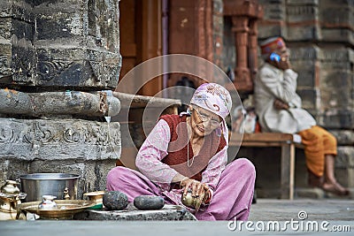 Old Indian woman cleans the dishes Editorial Stock Photo