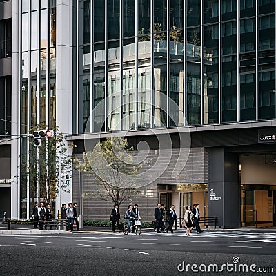 Nagoya, Aichi, Japan - Japanese office workers crossing the road in front of Nagoya Station. Editorial Stock Photo