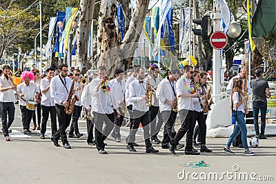 Philharmonic musicians with instruments go on carnival of Adloyada in Nahariyya, Israel Editorial Stock Photo