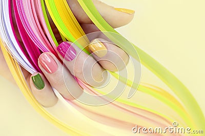 Nail art.Pink, green ,yellow, peach nail Polish. Stock Photo