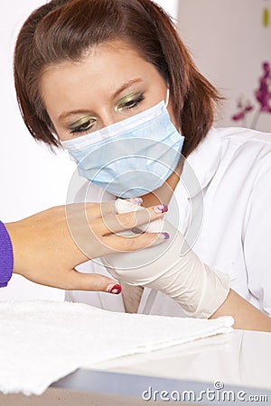 Nail designer checking acrylic fingernails Stock Photo