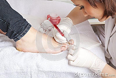 Nail designer working on acrylic toenails Stock Photo