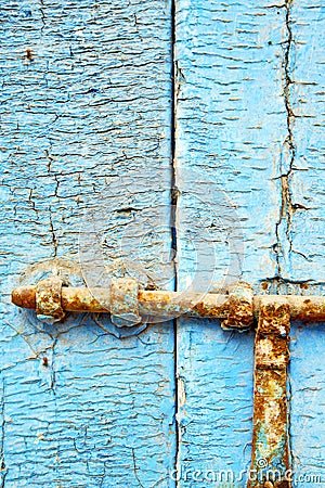 nail dirty stripped paint in the blue wood door Stock Photo