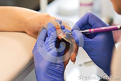 Nail extension with gel Treatment hand and nail care, the woman to a beautician for a manicure. Stock Photo