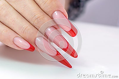 Nail Polish. Art Manicure. Modern style red black gradient Nail Polish. Beauty hands with Stylish Colorful trendy Nails w Stock Photo