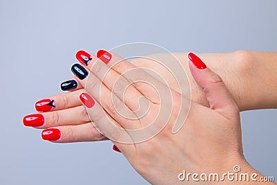 Nail Polish. Art Manicure. Modern style red black gradient Nail Polish with triangle on one nail finger. Stylish Colorful trendy Stock Photo