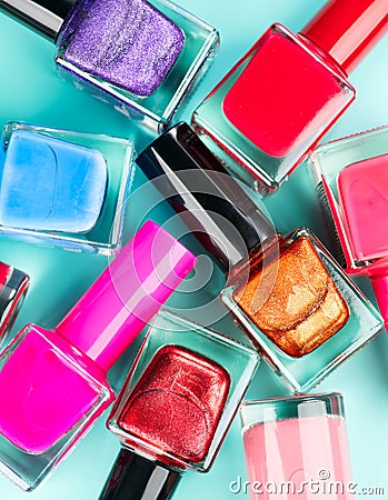 Nail polish colorful bottles. Manicure concept. Top view. Nailpolish colourful bottles over blue background Stock Photo